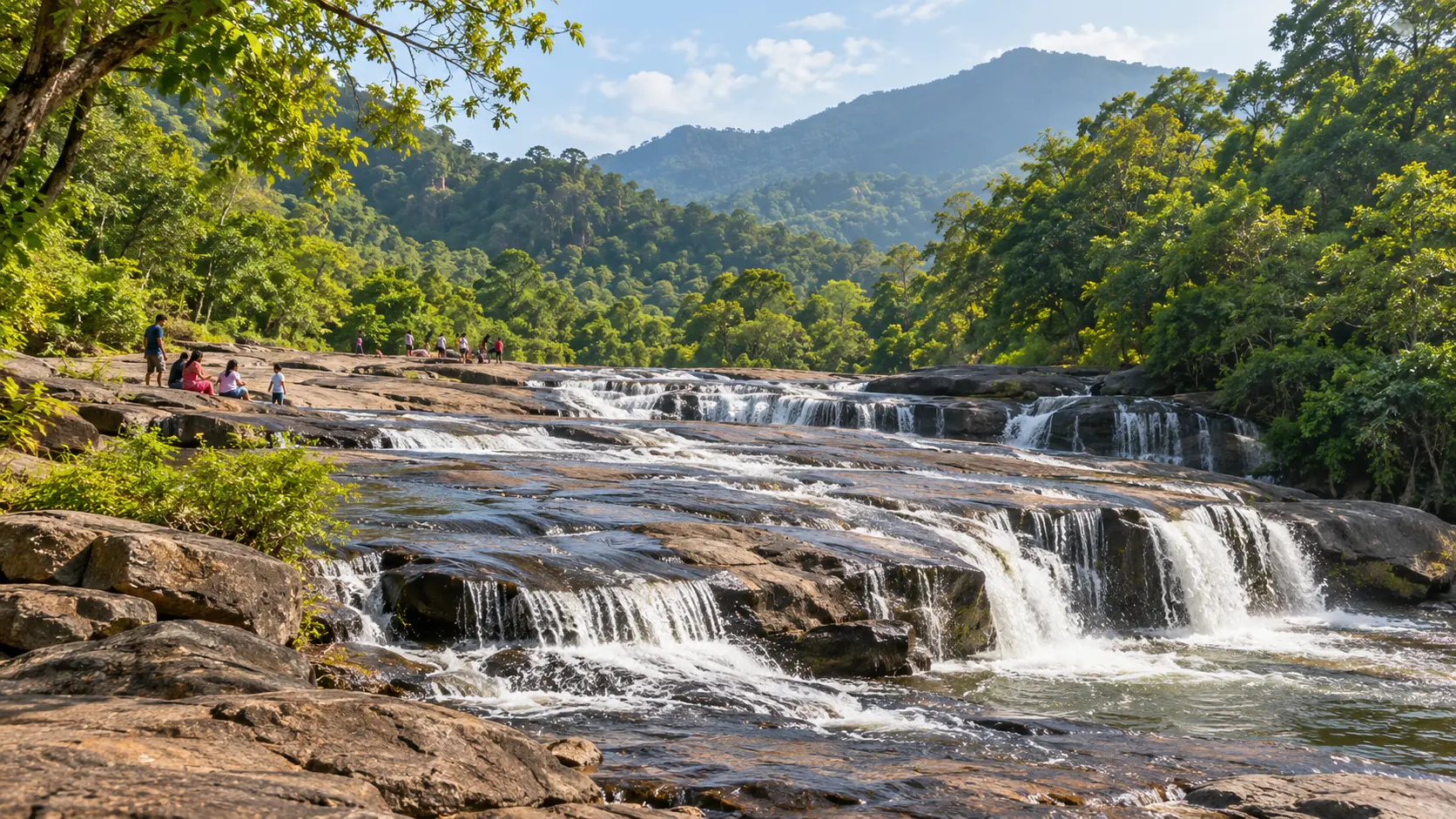 Water flowing over broad rocks at Chaparai Water Cascades near Araku
