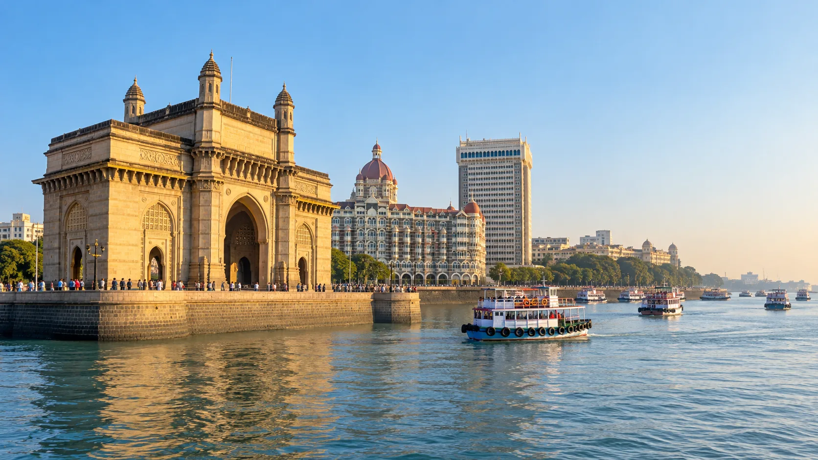 Gateway of India beside Mumbai Harbour with passenger ferries