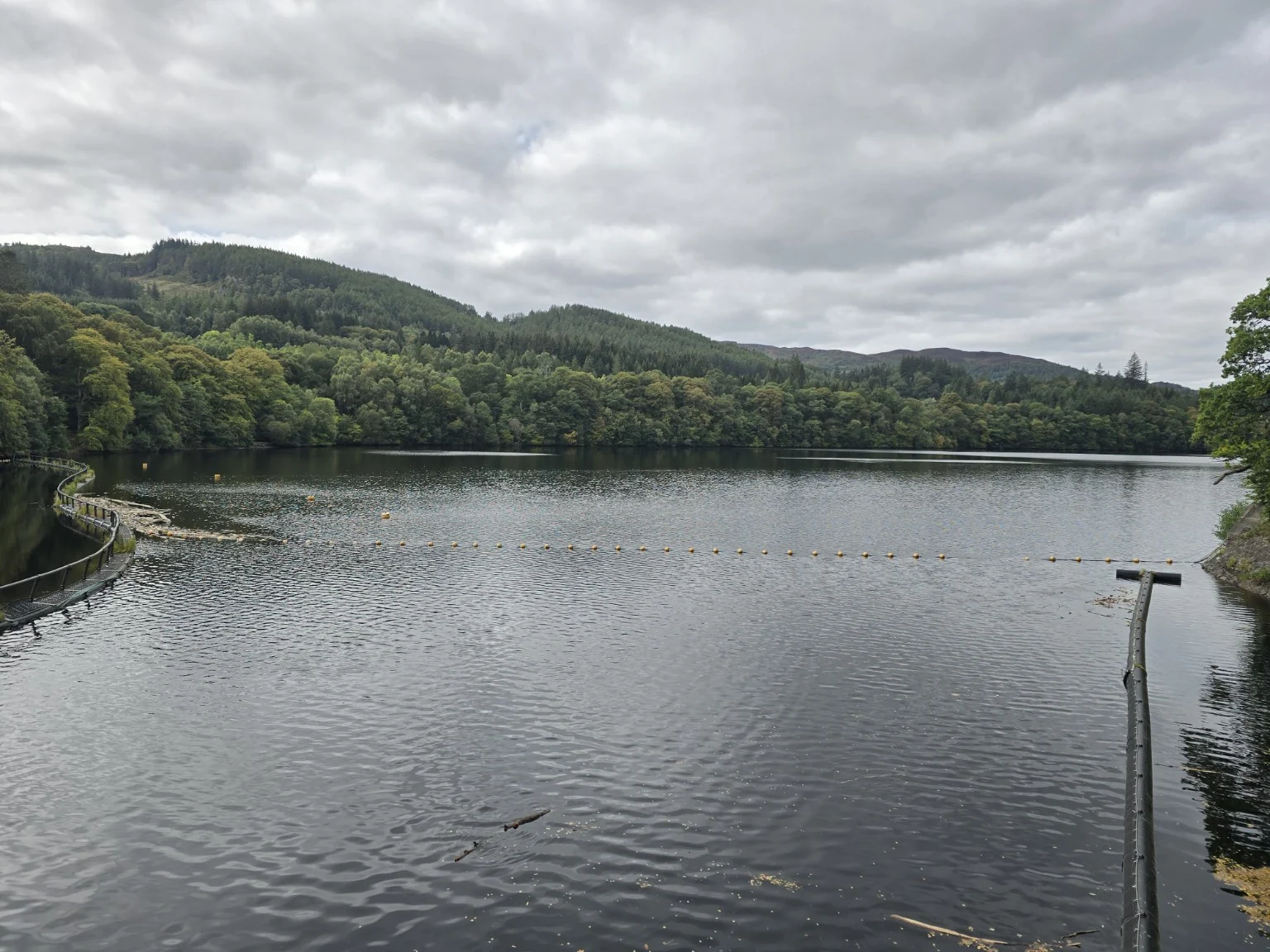 Pitlochry reservoir surrounded by forested hills